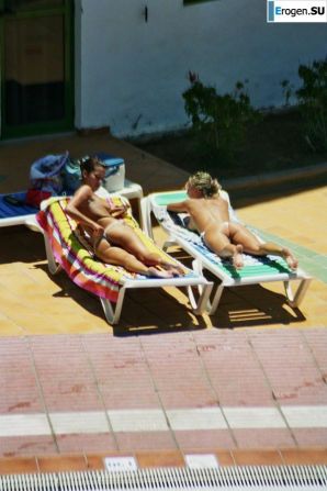 Girls sunbathe topless near the pool. Thumbnail 13