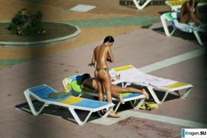 Girls sunbathe topless near the pool. Thumbnail 22