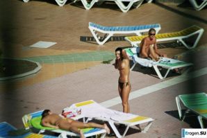 Girls sunbathe topless near the pool. Thumbnail 24