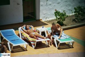 Girls sunbathe topless near the pool. Thumbnail 28