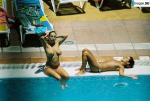 Girls sunbathe topless near the pool. Thumbnail 3