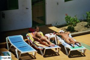 Girls sunbathe topless near the pool. Thumbnail 36