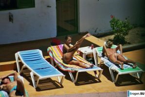 Girls sunbathe topless near the pool. Thumbnail 37