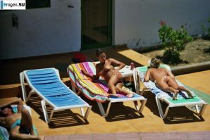 Girls sunbathe topless near the pool. Thumbnail 38