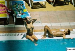 Girls sunbathe topless near the pool. Thumbnail 4