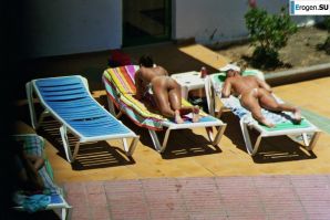 Girls sunbathe topless near the pool. Thumbnail 40