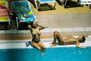 Girls sunbathe topless near the pool. Thumbnail 5
