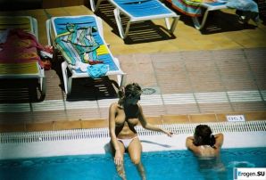 Girls sunbathe topless near the pool. Thumbnail 8