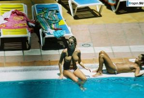 Girls sunbathe topless near the pool. Thumbnail 9