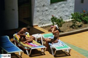 Girls sunbathe topless near the pool. Part 2. Thumbnail 1