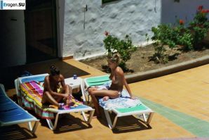 Girls sunbathe topless near the pool. Part 2. Thumbnail 2