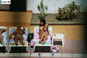 Girls sunbathe topless near the pool. Part 2. Thumbnail 3