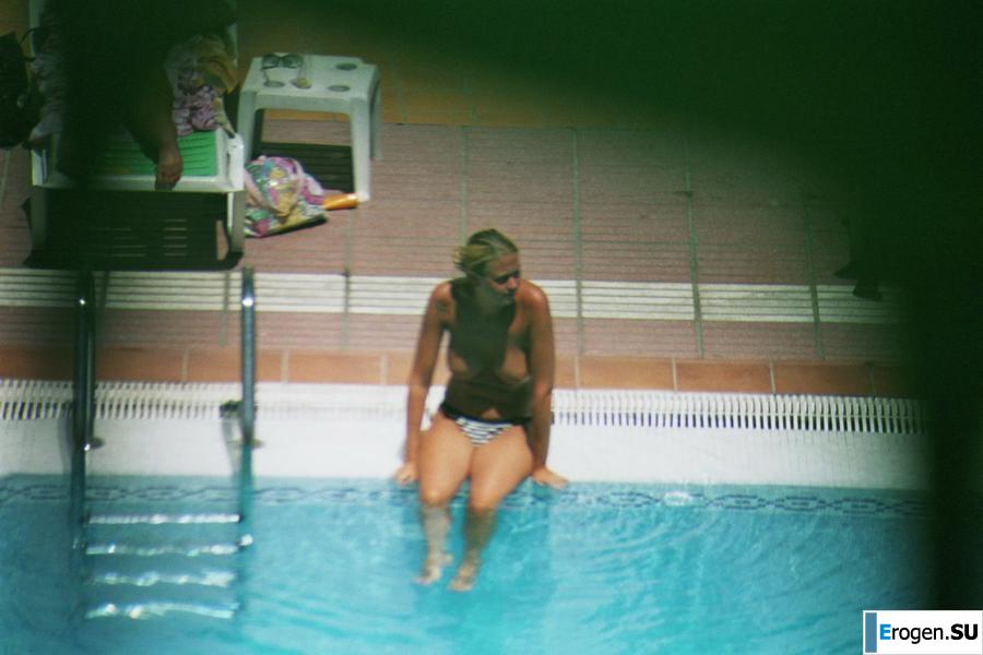 Girls sunbathe topless near the pool. Part 3. Slide 10