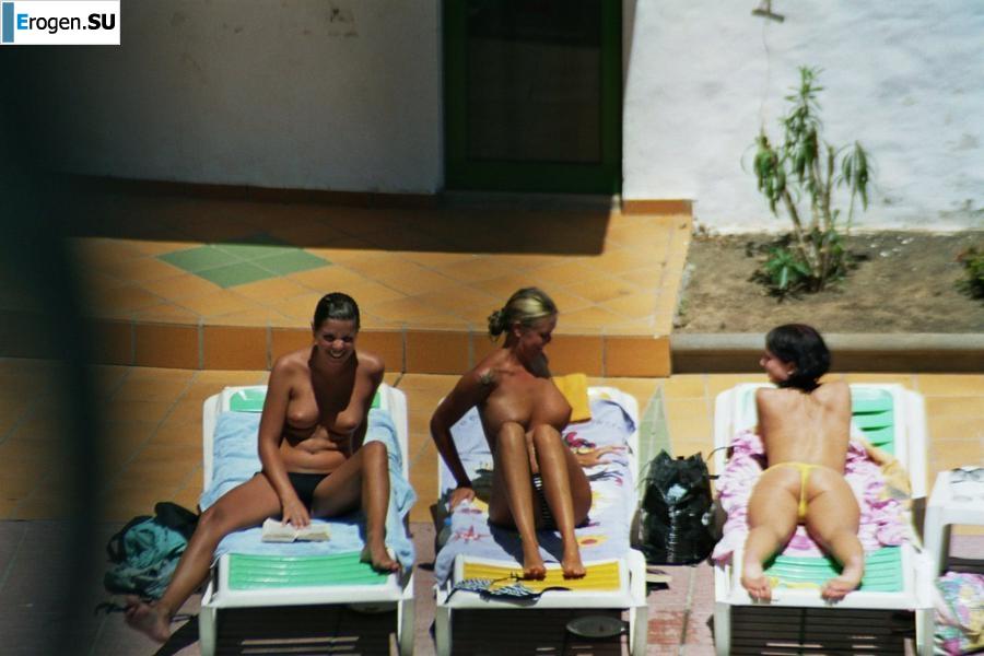 Girls sunbathe topless near the pool. Part 3. Slide 13