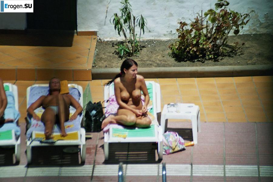 Girls sunbathe topless near the pool. Part 3. Slide 15