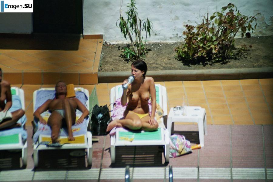 Girls sunbathe topless near the pool. Part 3. Slide 16