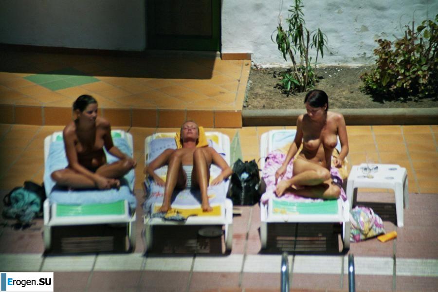 Girls sunbathe topless near the pool. Part 3. Slide 2