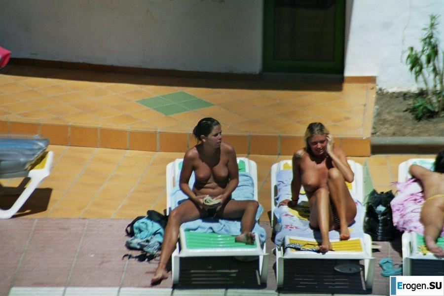 Girls sunbathe topless near the pool. Part 3. Slide 20