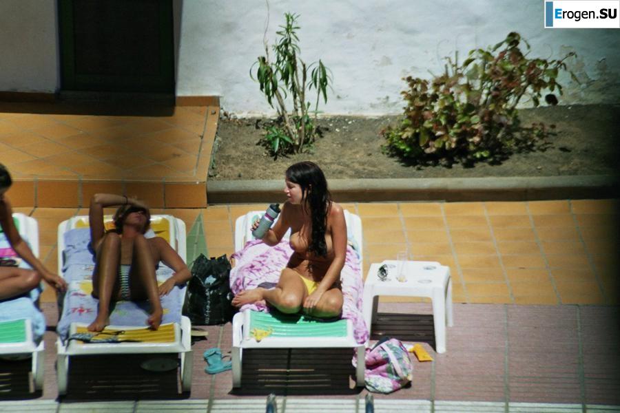 Girls sunbathe topless near the pool. Part 3. Slide 22