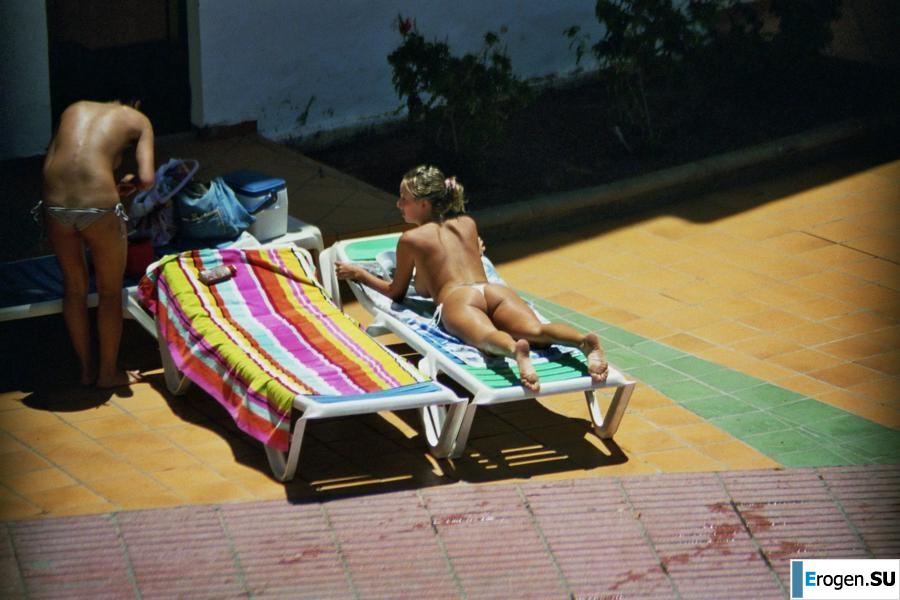 Girls sunbathe topless near the pool. Part 3. Slide 23