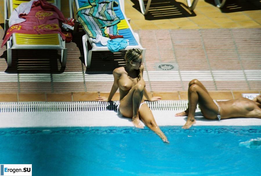 Girls sunbathe topless near the pool. Part 3. Slide 27