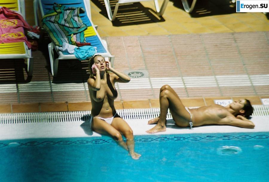 Girls sunbathe topless near the pool. Part 3. Slide 31