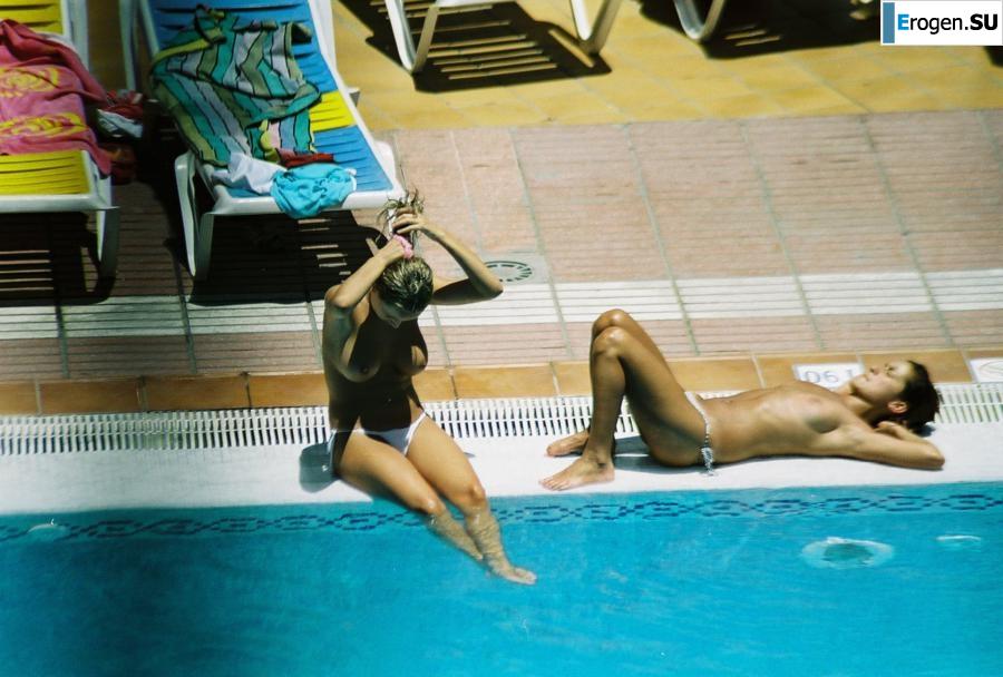 Girls sunbathe topless near the pool. Part 3. Slide 32