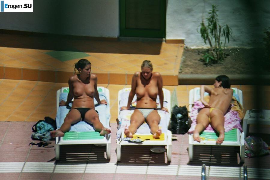 Girls sunbathe topless near the pool. Part 3. Slide 8