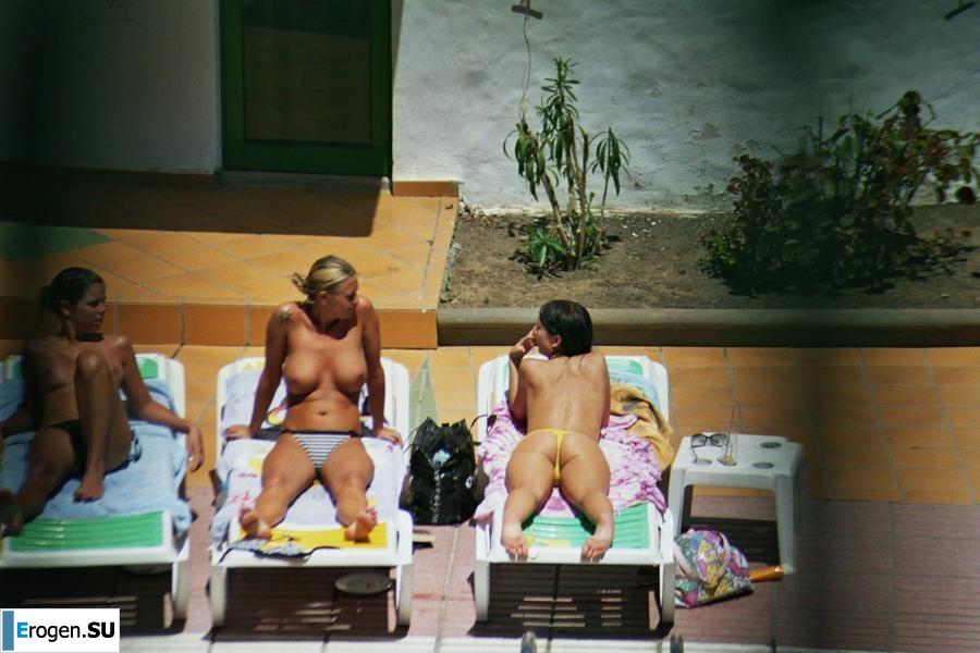 Girls sunbathe topless near the pool. Part 3. Slide 9