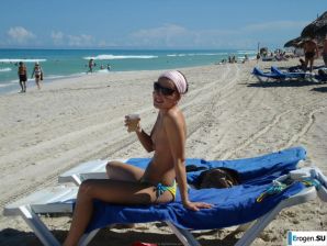resting naked on the beach. Thumbnail 1
