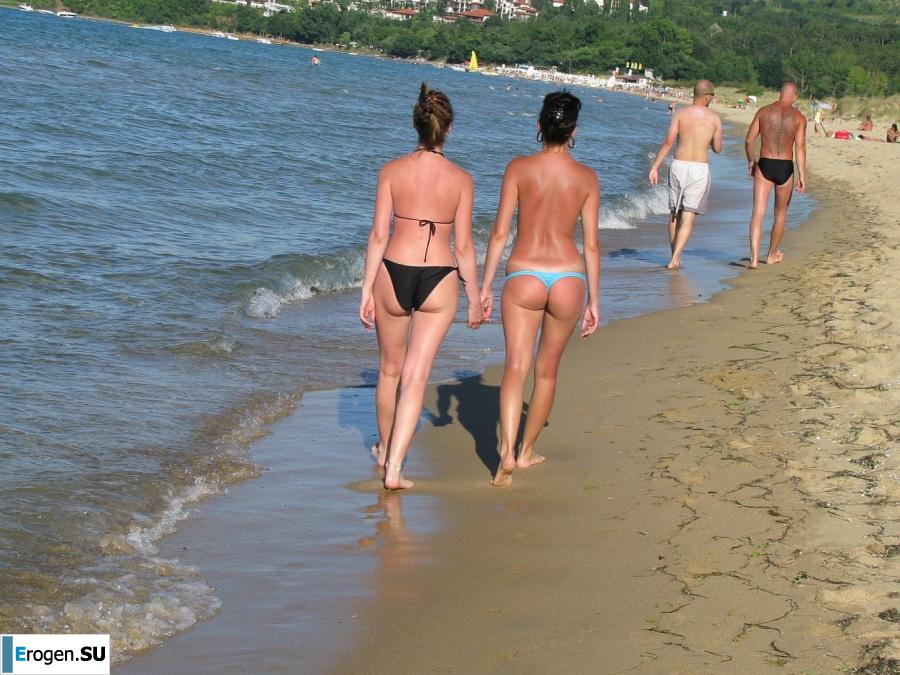 tanned girlfriends on a rocky shore. Slide 15