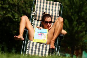 undressed outdoors in front of the photographer. Thumbnail 1