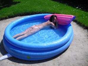 three girlfriends sunbathe in the yard with bare breasts. Part 2. Thumbnail 1