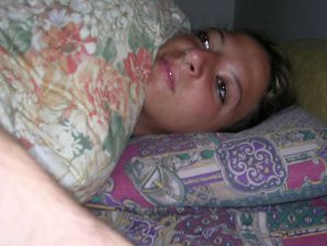 A tanned brunette shines her tits in the morning in bed. Thumbnail 12