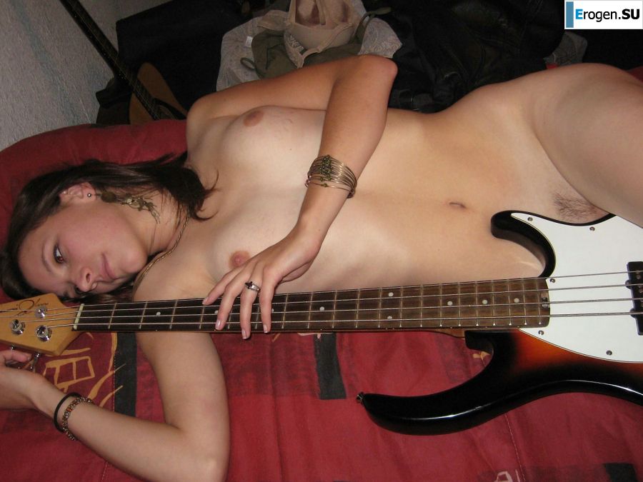 A naked chick poses with a guitar, and a guy licks her. Slide 8
