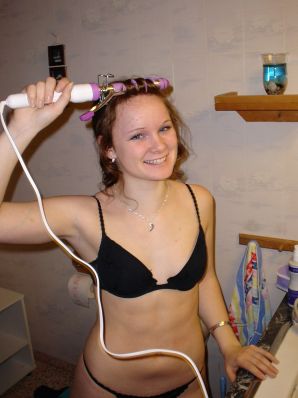 A blue-eyed minx with a pierced nipple plays with her panties. Thumbnail 3