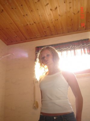 A blue-eyed minx with a pierced nipple plays with her panties. Thumbnail 9