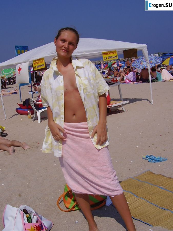 Sexy girl posing on the beach in shorts without a bra. Slide 13