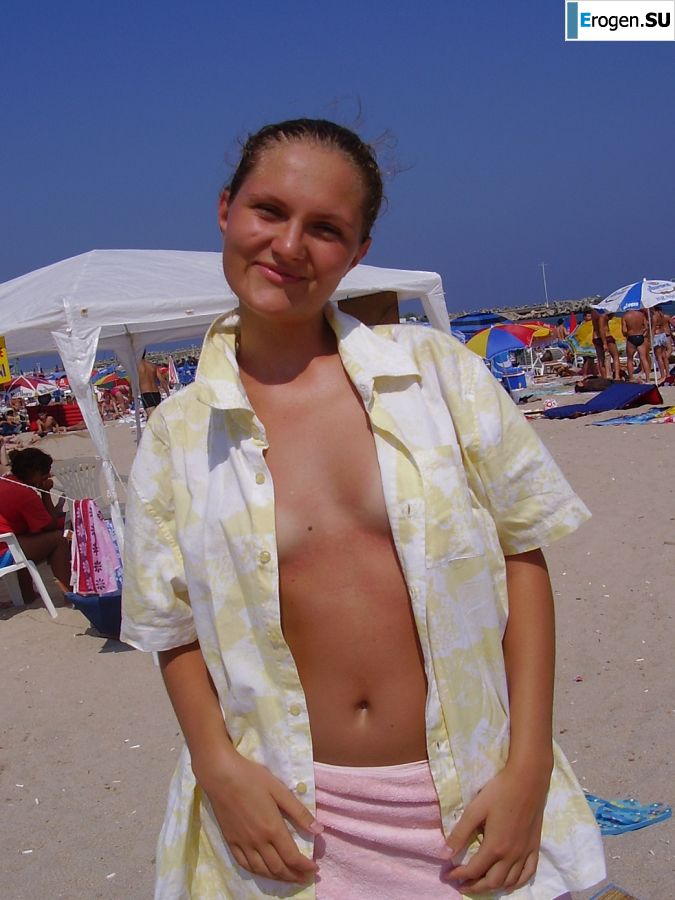 Sexy girl posing on the beach in shorts without a bra. Slide 14