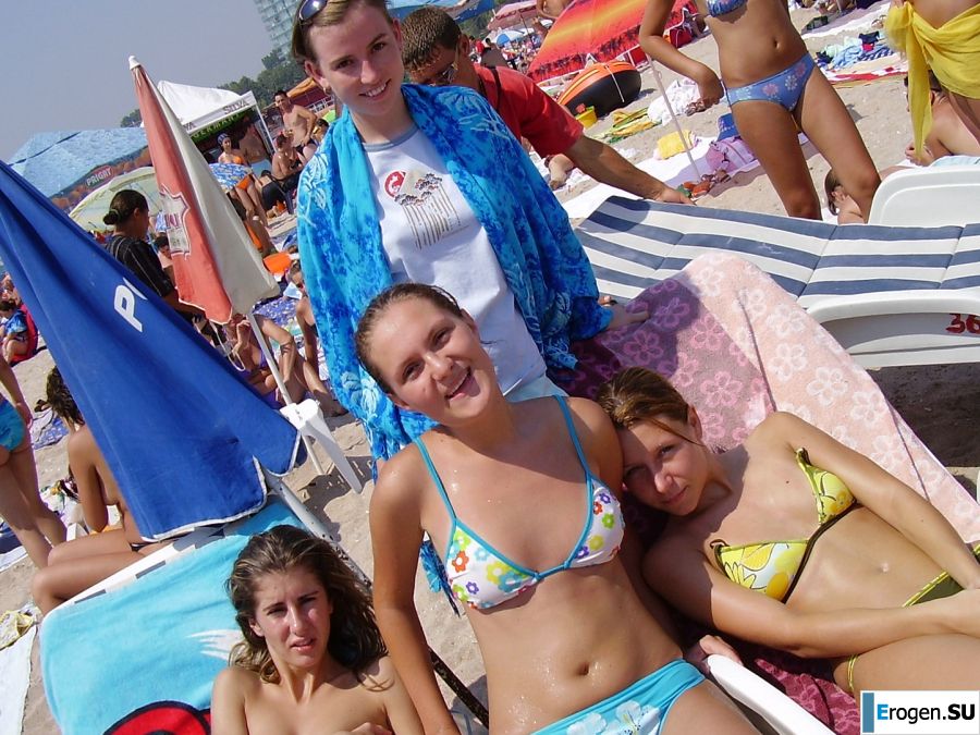 Sexy girl posing on the beach in shorts without a bra. Slide 3
