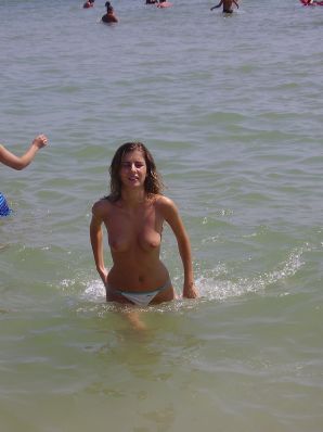 Sexy girl posing on the beach in shorts without a bra. Thumbnail 11