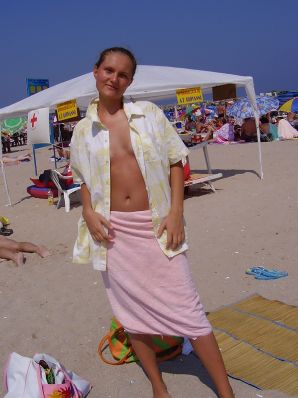 Sexy girl posing on the beach in shorts without a bra. Thumbnail 13