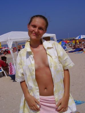 Sexy girl posing on the beach in shorts without a bra. Thumbnail 14