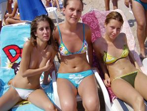Sexy girl posing on the beach in shorts without a bra. Thumbnail 2
