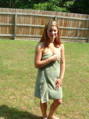 A blonde with a beautiful figure poses naked on the lawn. Thumbnail 13