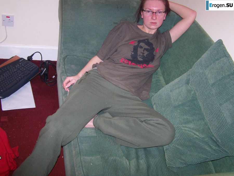 The red-haired beauty with a shaved pussy poses in one jacket. Slide 1