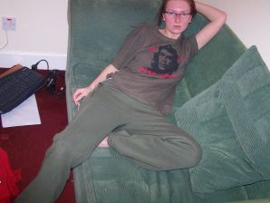 The red-haired beauty with a shaved pussy poses in one jacket. Thumbnail 1