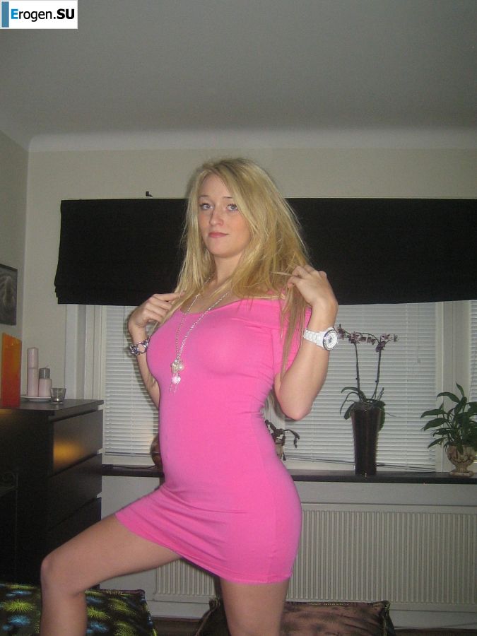 A blonde with silicone breast poses in a short skirt. Slide 14