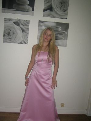A blonde with silicone breast poses in a short skirt. Thumbnail 16