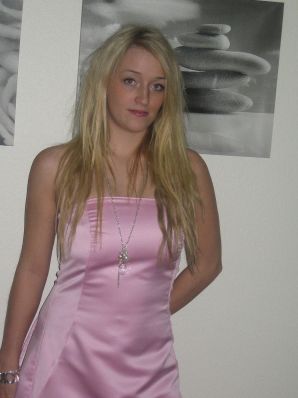 A blonde with silicone breast poses in a short skirt. Thumbnail 17